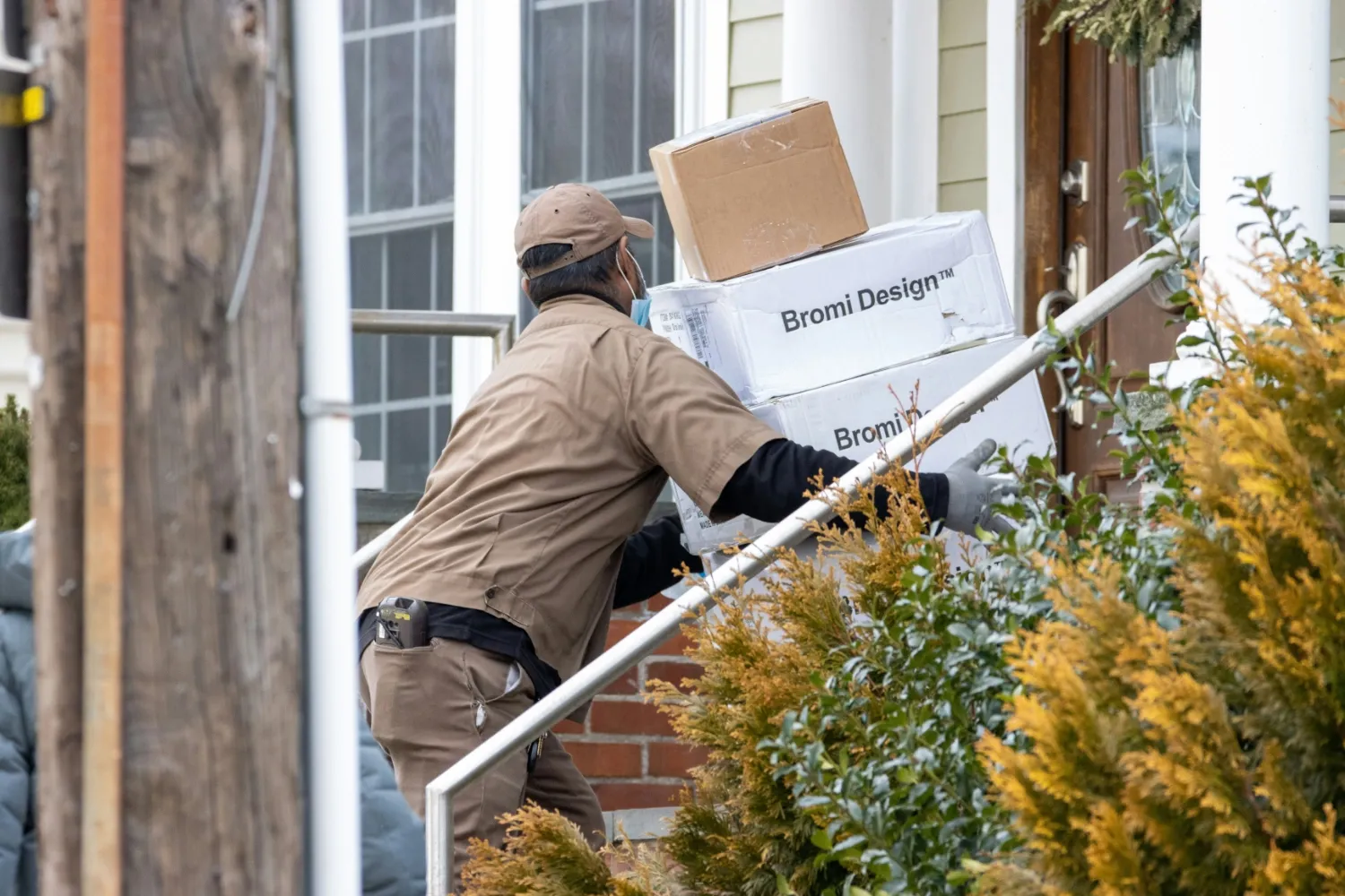 A delivery driver delivering packages to someone's front door.