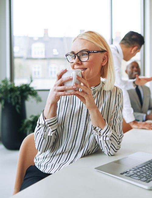 woman drinking cup of coffee in the office