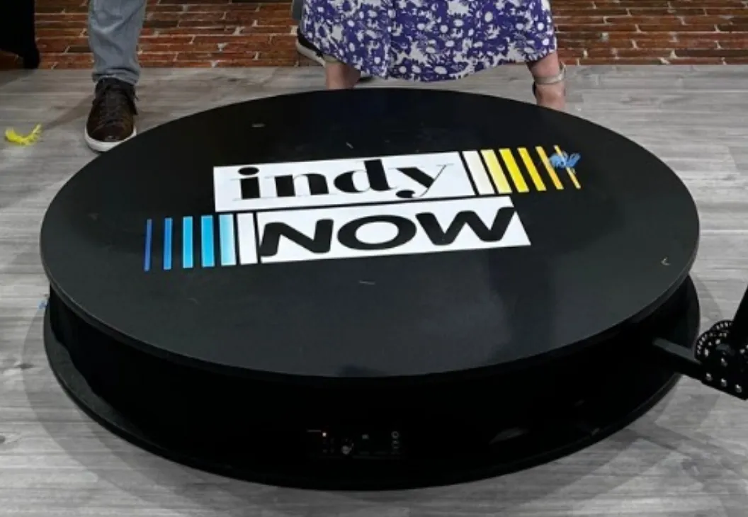 Square floor platform with the Indy Now logo, designed for use with a 360° photo booth experience.