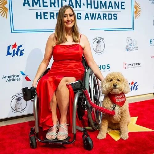 A Hero dog and their human posing on the red carpet