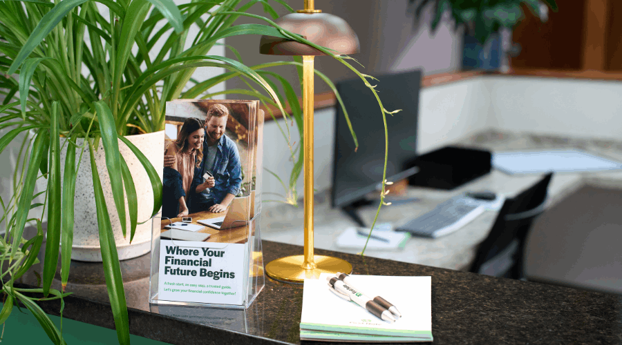 Brochures and notepads sitting on a financial desk