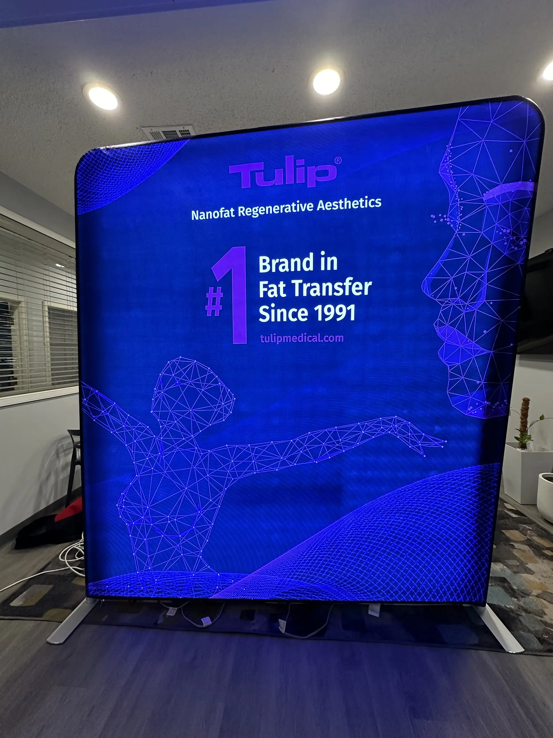 Large-format trade show backdrop featuring life sciences branding and messaging, printed by AlphaGraphics San Diego