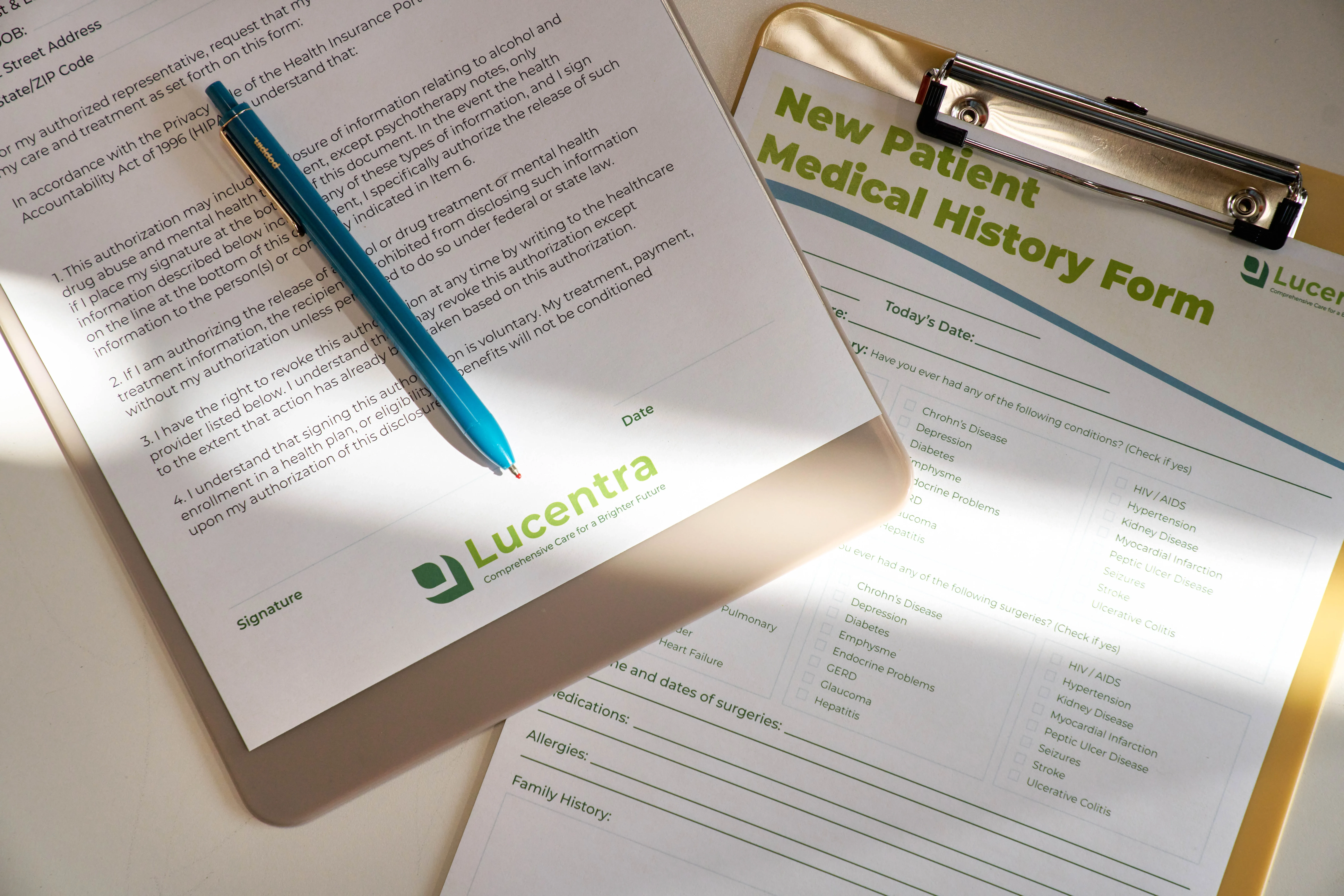 Custom printed healthcare forms and patient medical history paperwork on a clipboard.