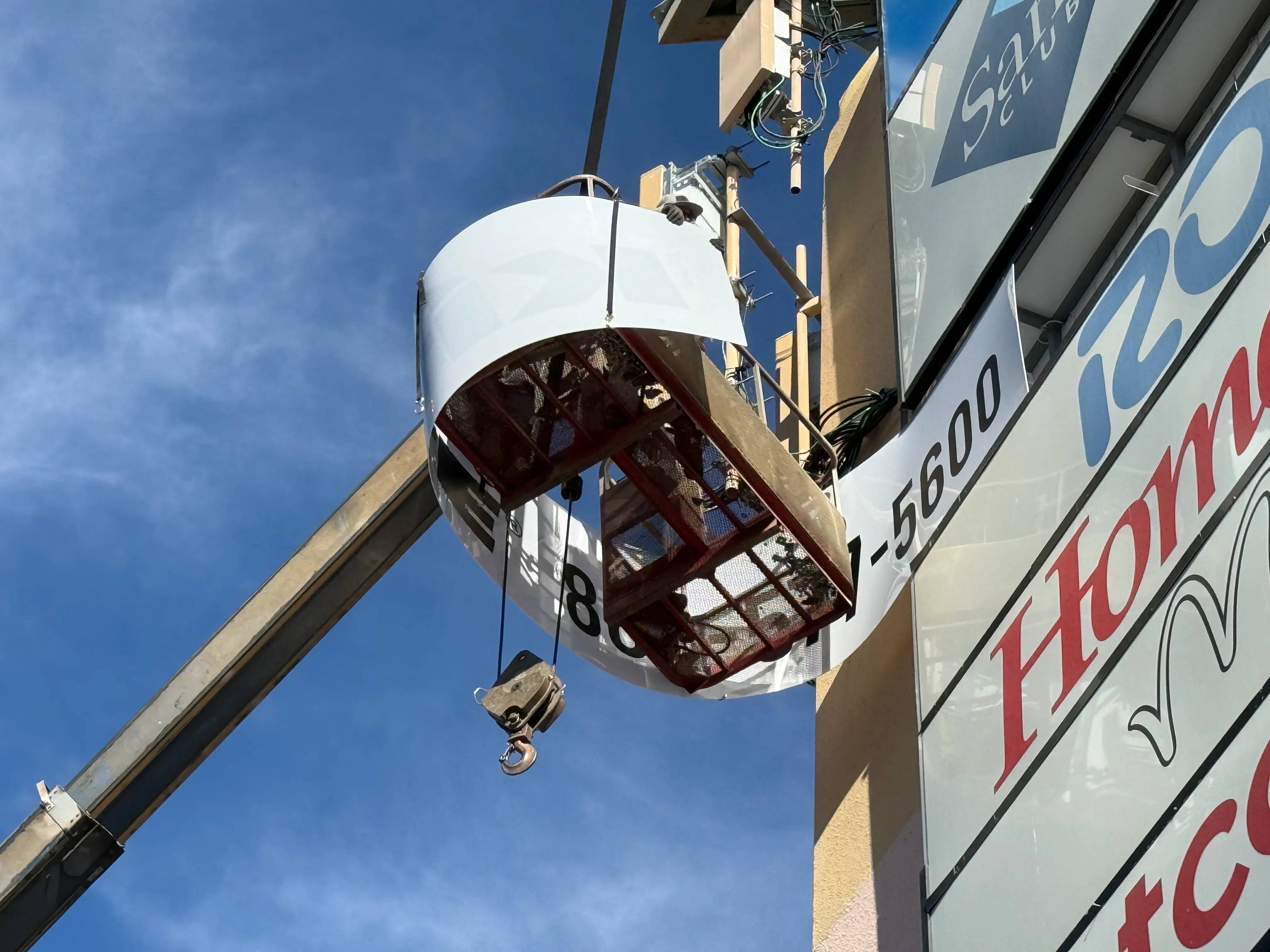Close-up of polycarbonate sign panel installation on pylon sign