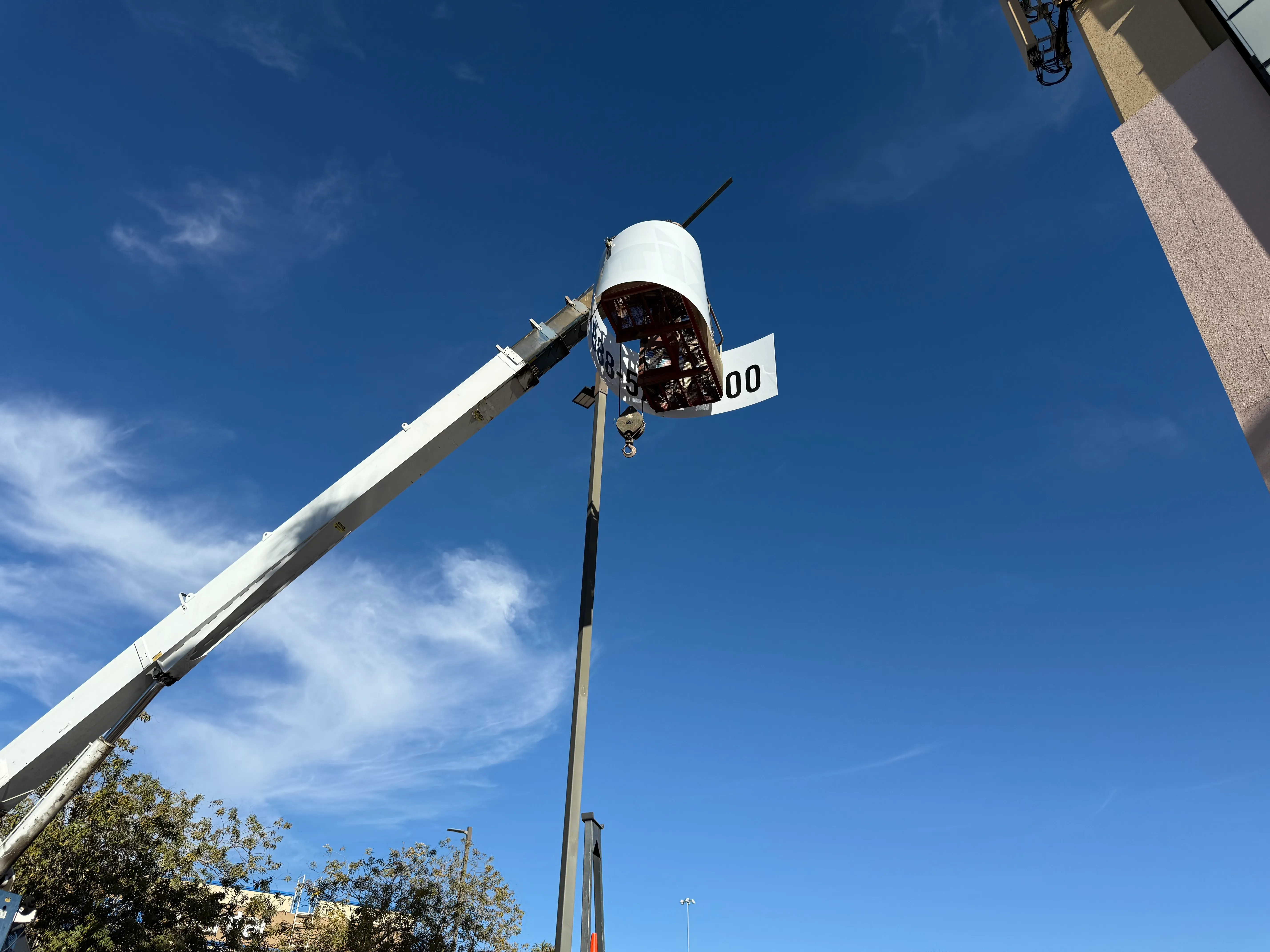 Polycarbonate sign panel being installed on retail pylon sign